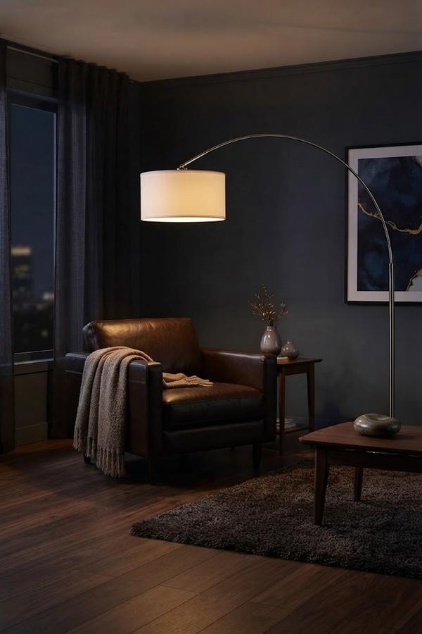 White drum shade arching over a reading chair